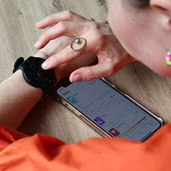 woman syncing OmniWatch with her phone